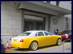 The old Bank of China Building with a strangely coloured Rolls-Royce in front.